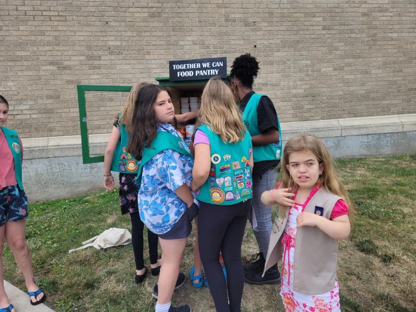 Girl Scouts fill a new food pantry on New Scotland Avenue in Albany in July 2022