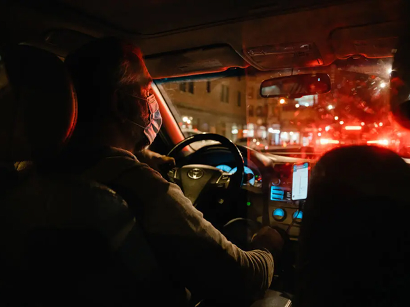 A ride share driver wearing a mask