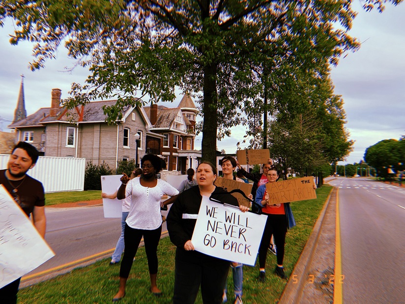 People protest abortion rights on a residential street