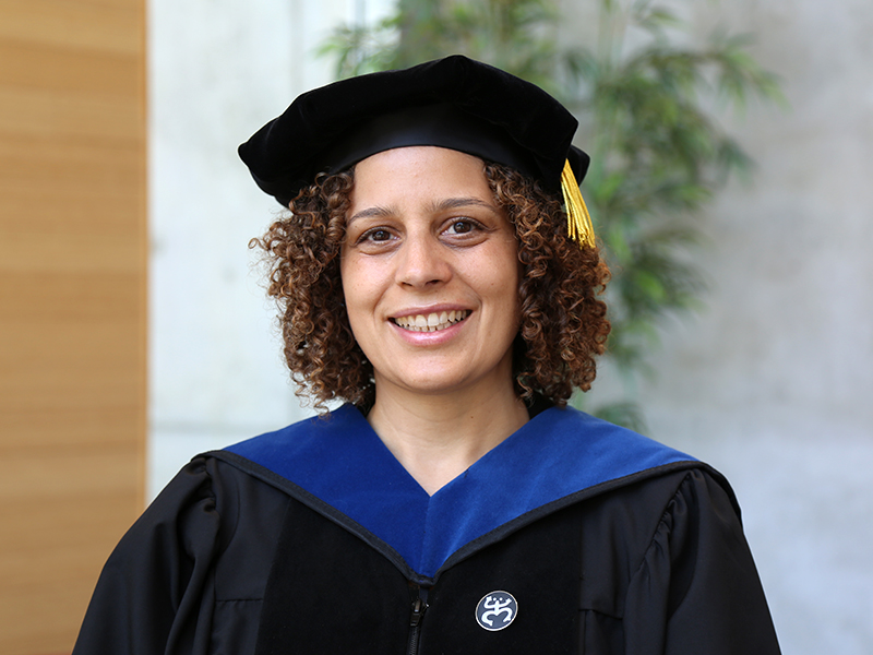 Yaminette Diaz-Linhart wearing a cap and gown