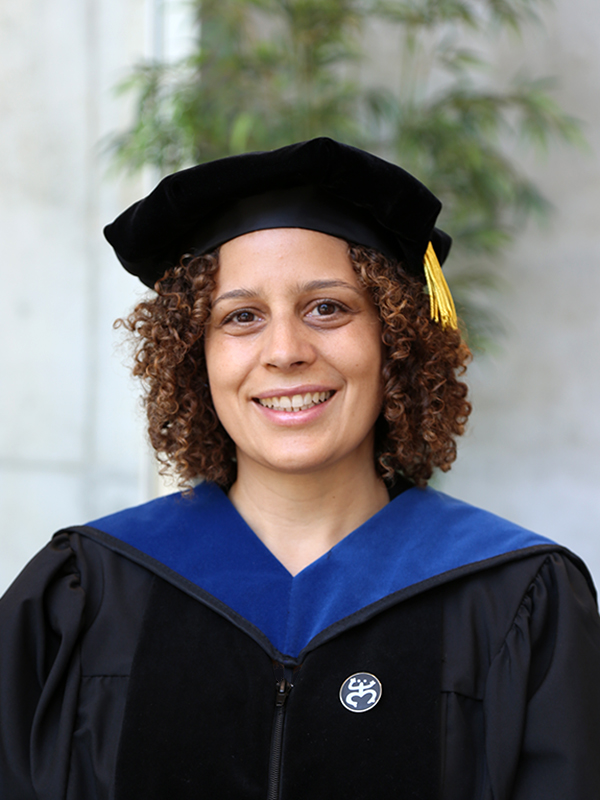 Yaminette Diaz-Linhart wearing a cap and gown