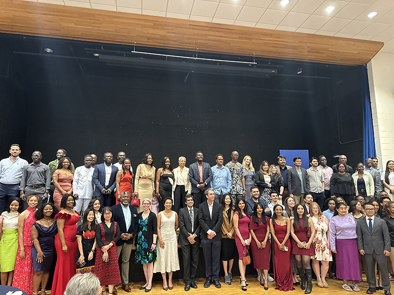 Heller 2025 graduates pose with Interim Dean Maria Madison