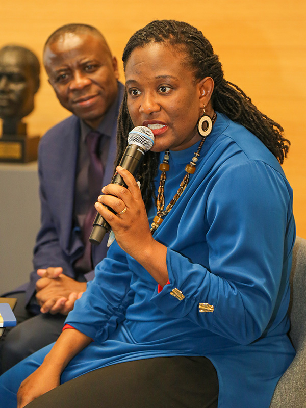 Gloria Mahama, MA SID'13, speaks at Heller on February 24, 2025, as Joseph Assan looks on