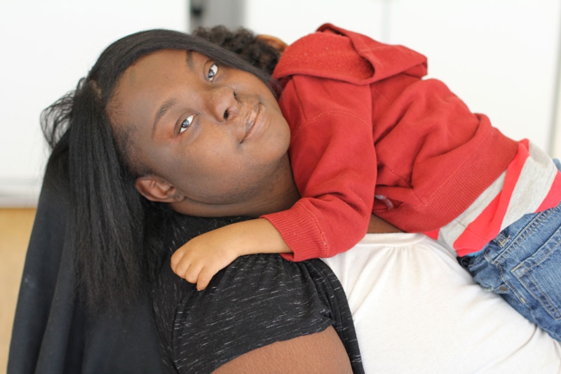 A mother with a developmental disability holding her small child