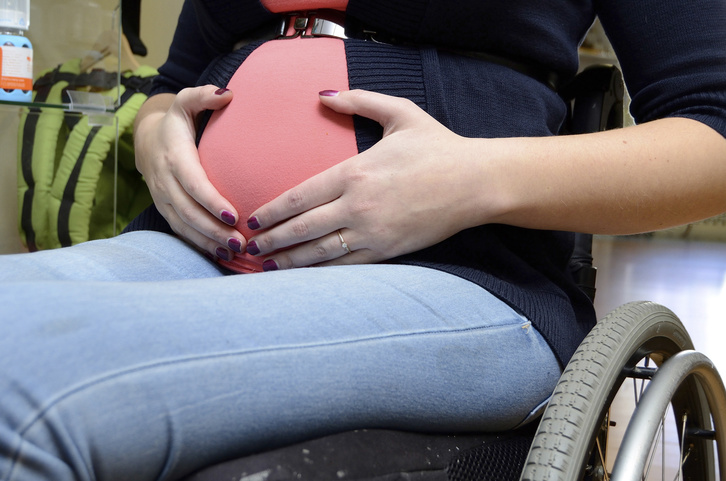 A pregnant woman using a wheelchair