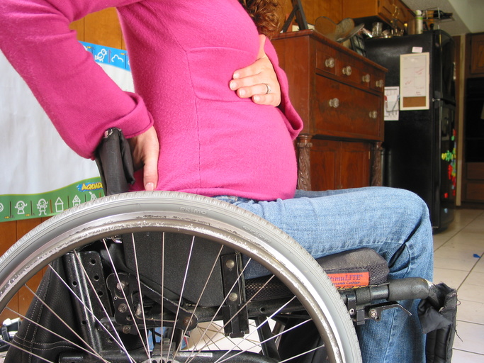 A pregnant woman using a wheelchair