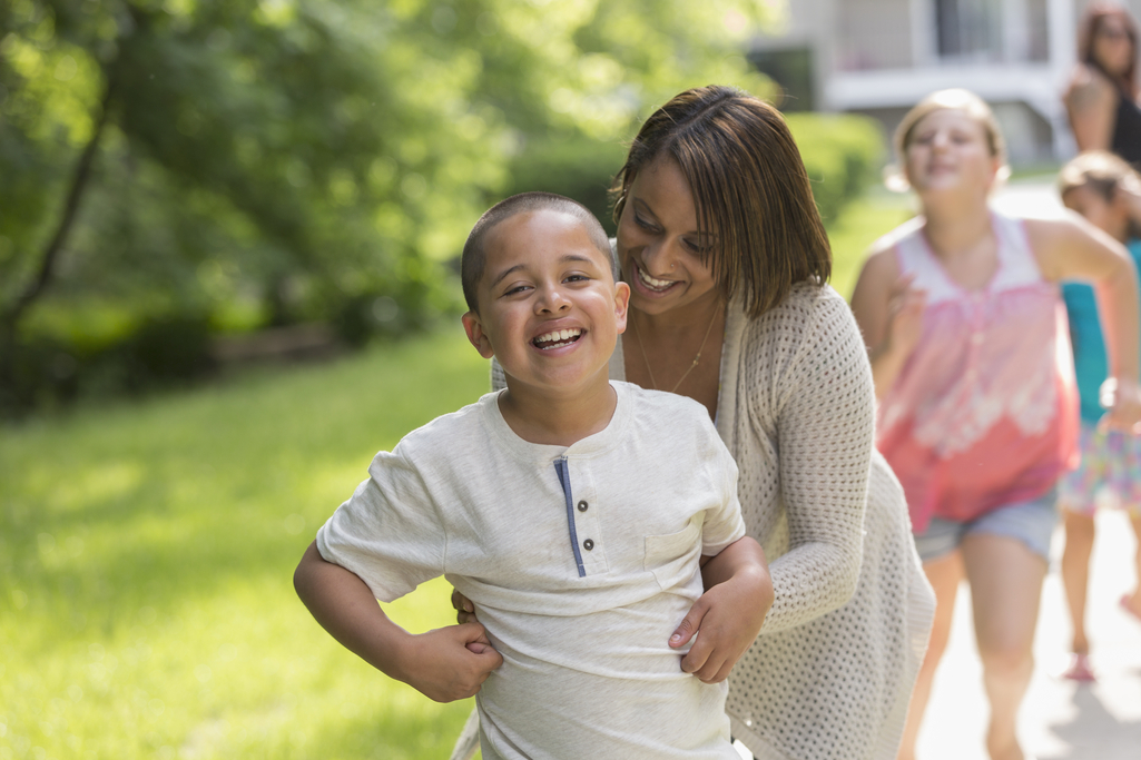 A young boy with his mother at the park