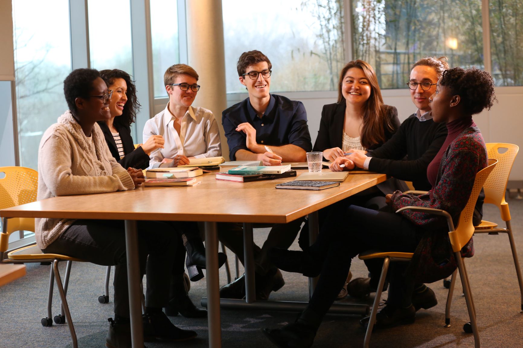 Segal Fellows having a discussion around a table