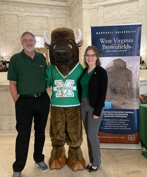 Catherine, standing on the right hand-side of Marco the Bison, and on the left is Catherine's colleague. 