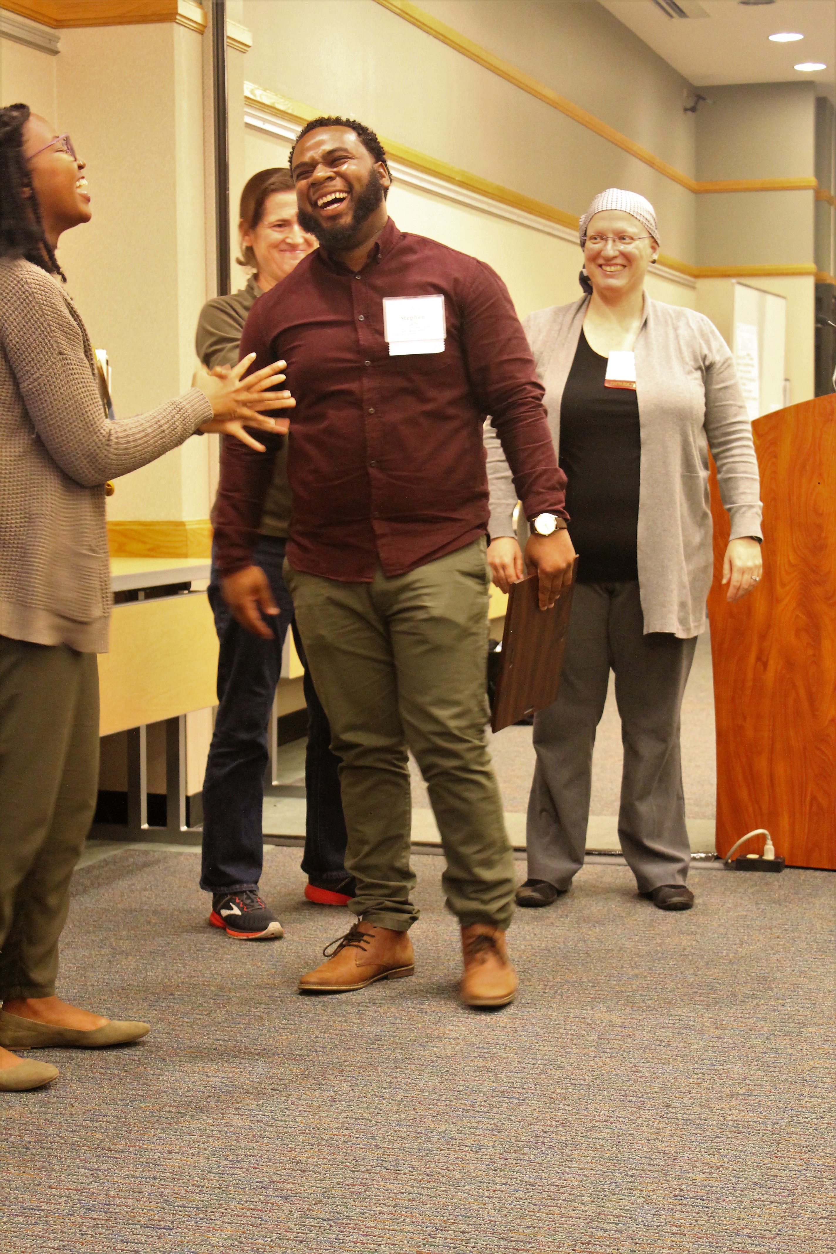 Segal Fellow and Fellow in Action Award Recipient Stephen Larbi laughing as he receives award from Segal Program with Fellow LaShawn Simmons