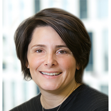 headshot of Valerie green smiling at camera in a black top