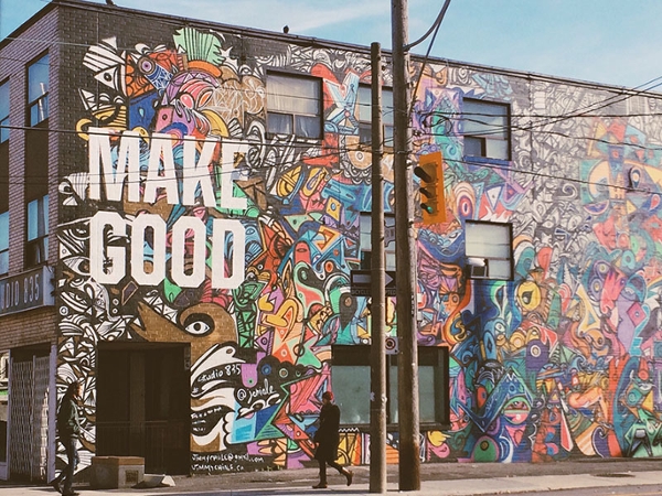Wall with "Make Good" mural painted on it