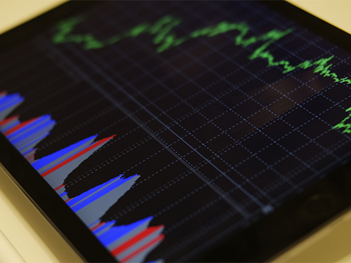 a tablet screen displaying graphs and data