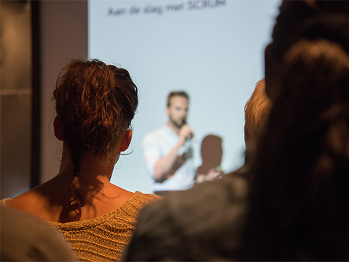 a person giving a presentation in front of young adults