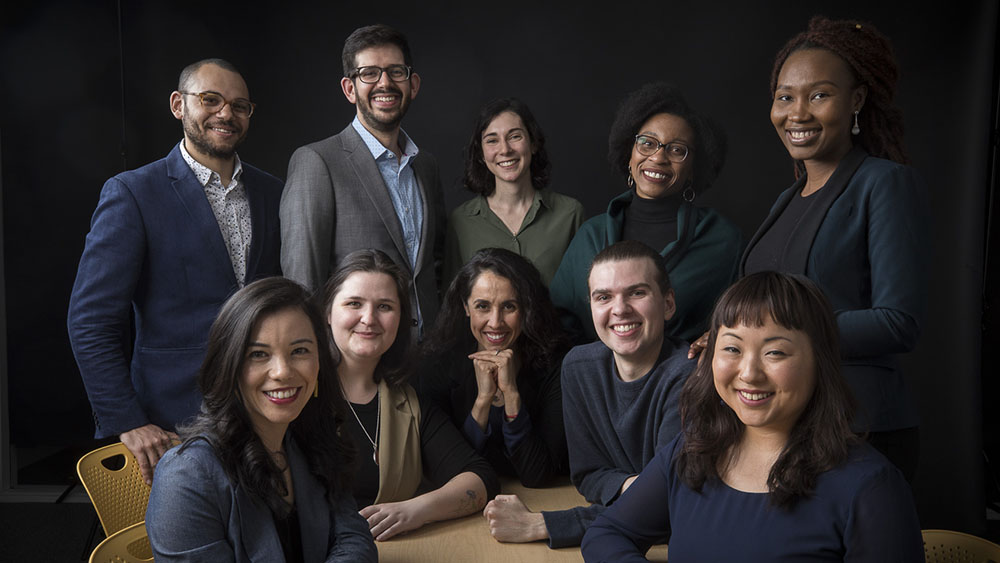 Smiling students against a black background