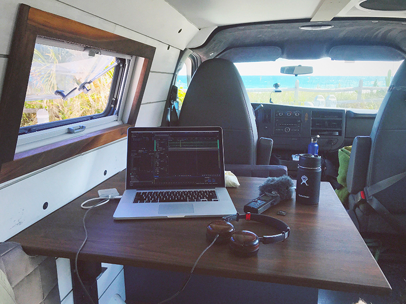 A laptop on a table inside of a van