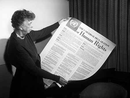 ELEANOR ROOSEVELT of the United States holding a poster of the Universal Declaration of Human Rights. Lake Success, NY, November 1949. UN Photo