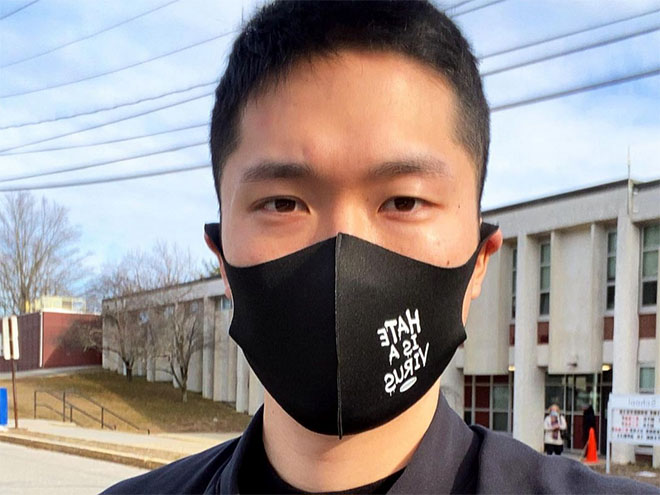 Sam Hyun, MBA/MPP'22, wearing a black face mask that says Hate is a Virus 
