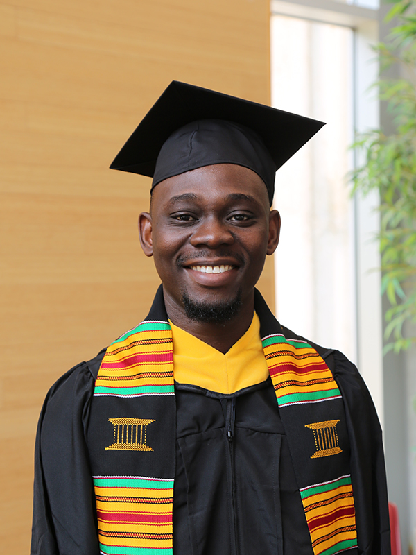 Kingsley Ojeikere wearing a cap and gown
